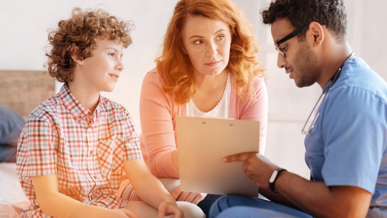 A mother and child talking to a doctor