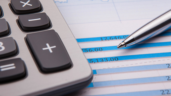 Financial reports Calculator, spreadsheet, and a pen