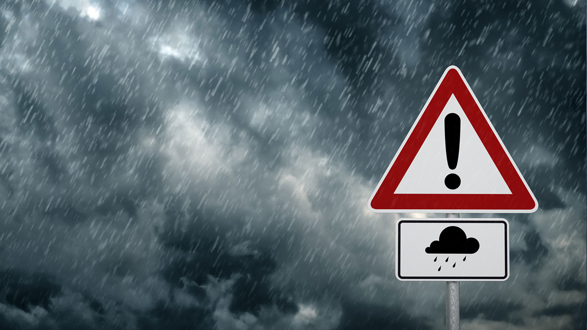 -- title missing -- Flood warning sign against stormy sky background