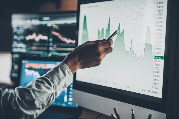 Person pointing to a computer with an epidemiologic curve on screen Person pointing to a computer with an epidemiologic curve on screen