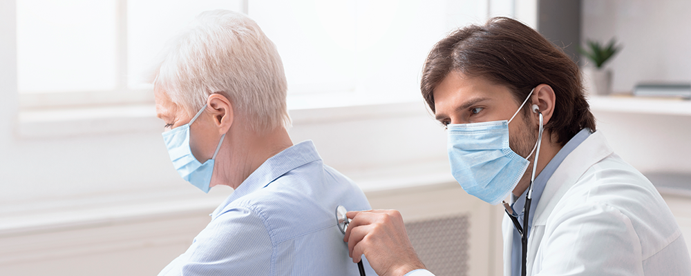 flu-symptoms-testing-775px Doctor using stethoscope on woman's back.