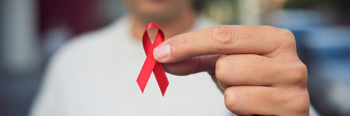 hiv-banner Man with red ribbon for the fight against AIDS