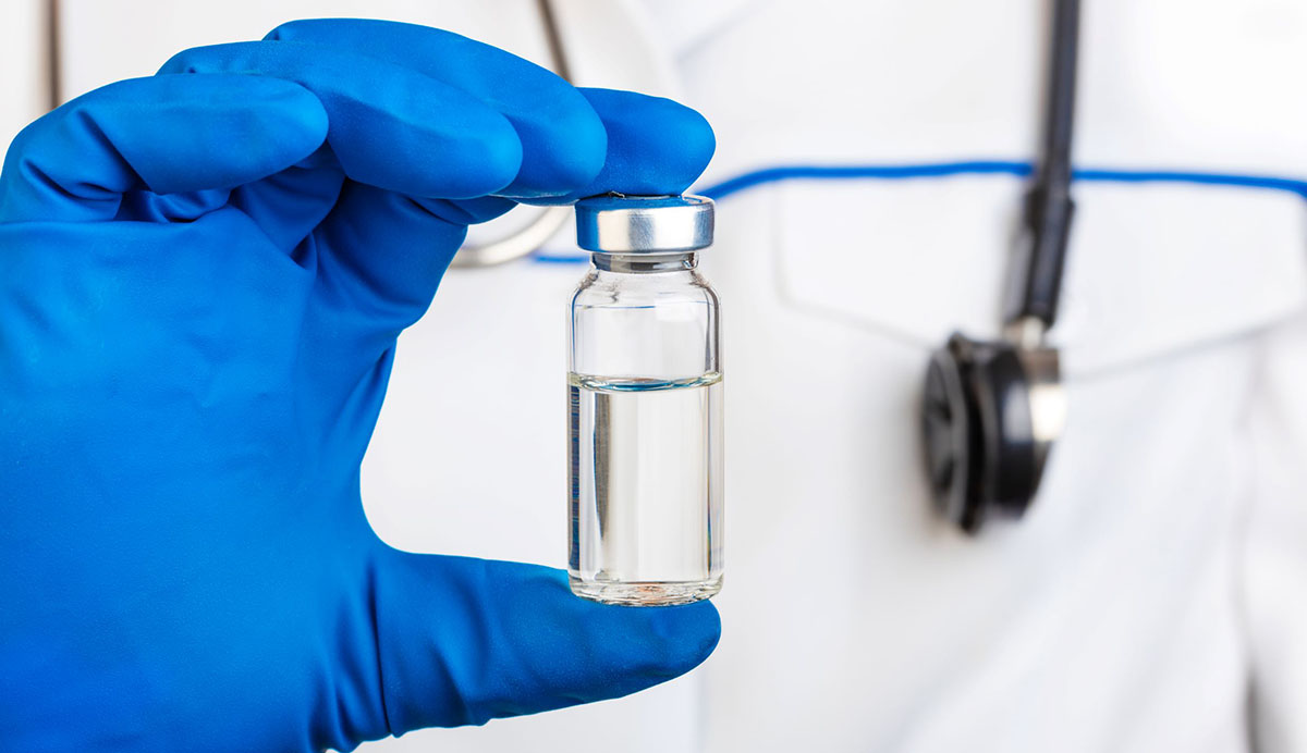 vaccine-bottle vaccine bottle held by health care professional