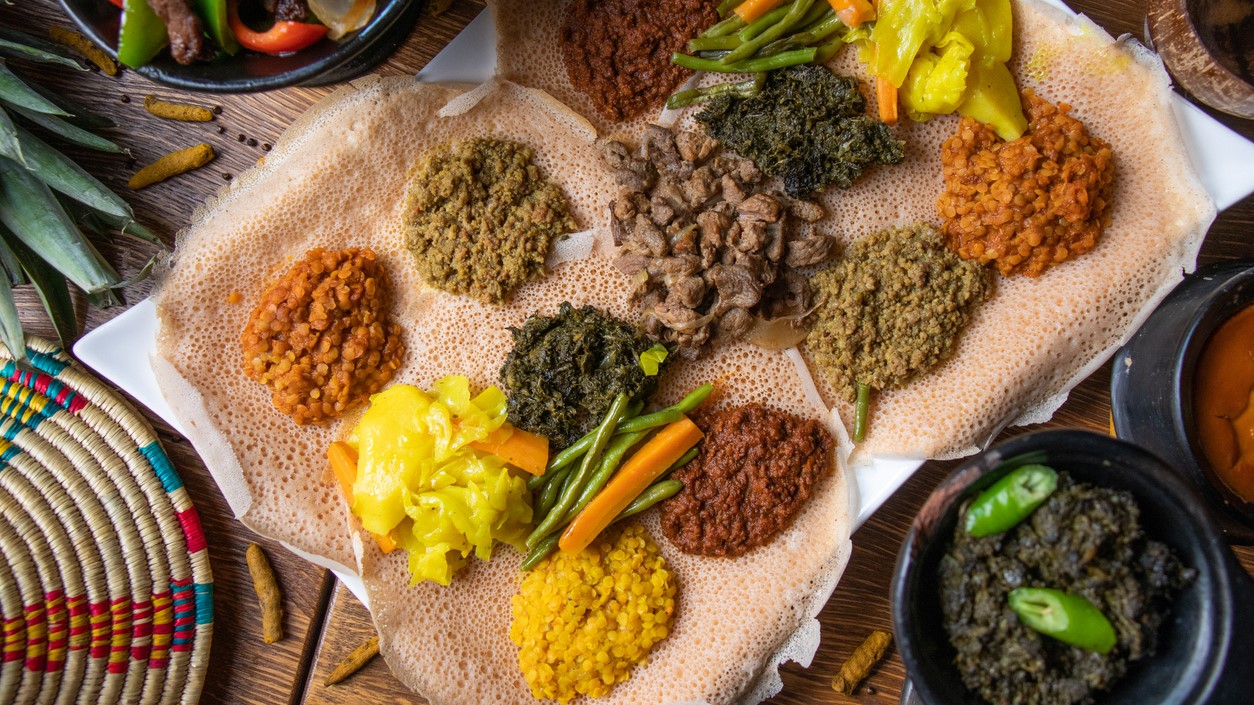 Cultural foods A sample of Ethiopian lentils, vegetables, and other foods on a bed of teff.