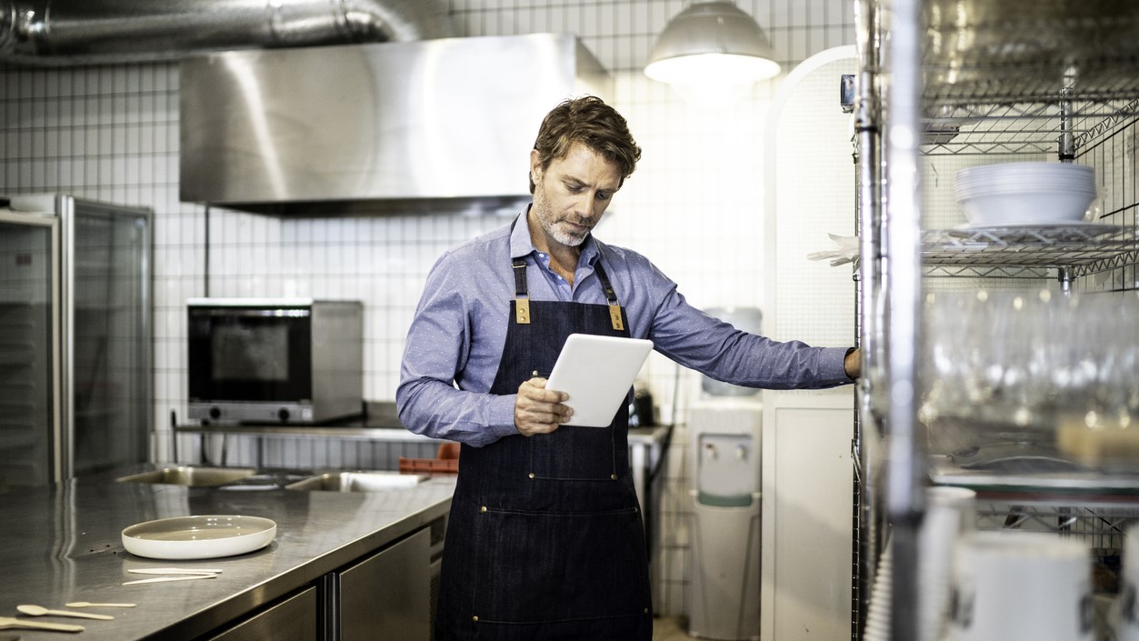 — title missing — Man monitoring inventory in kitchen