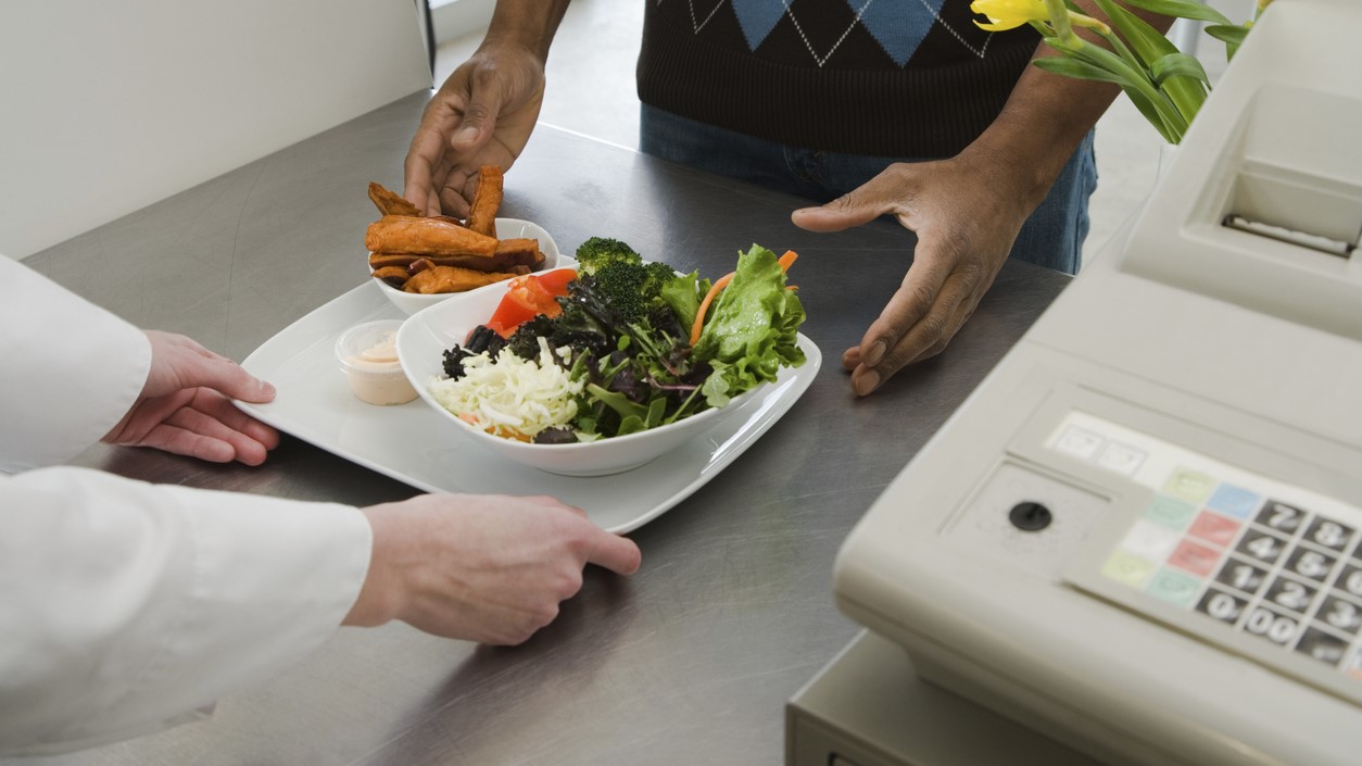 — title missing — Man receiving meal at cash register.