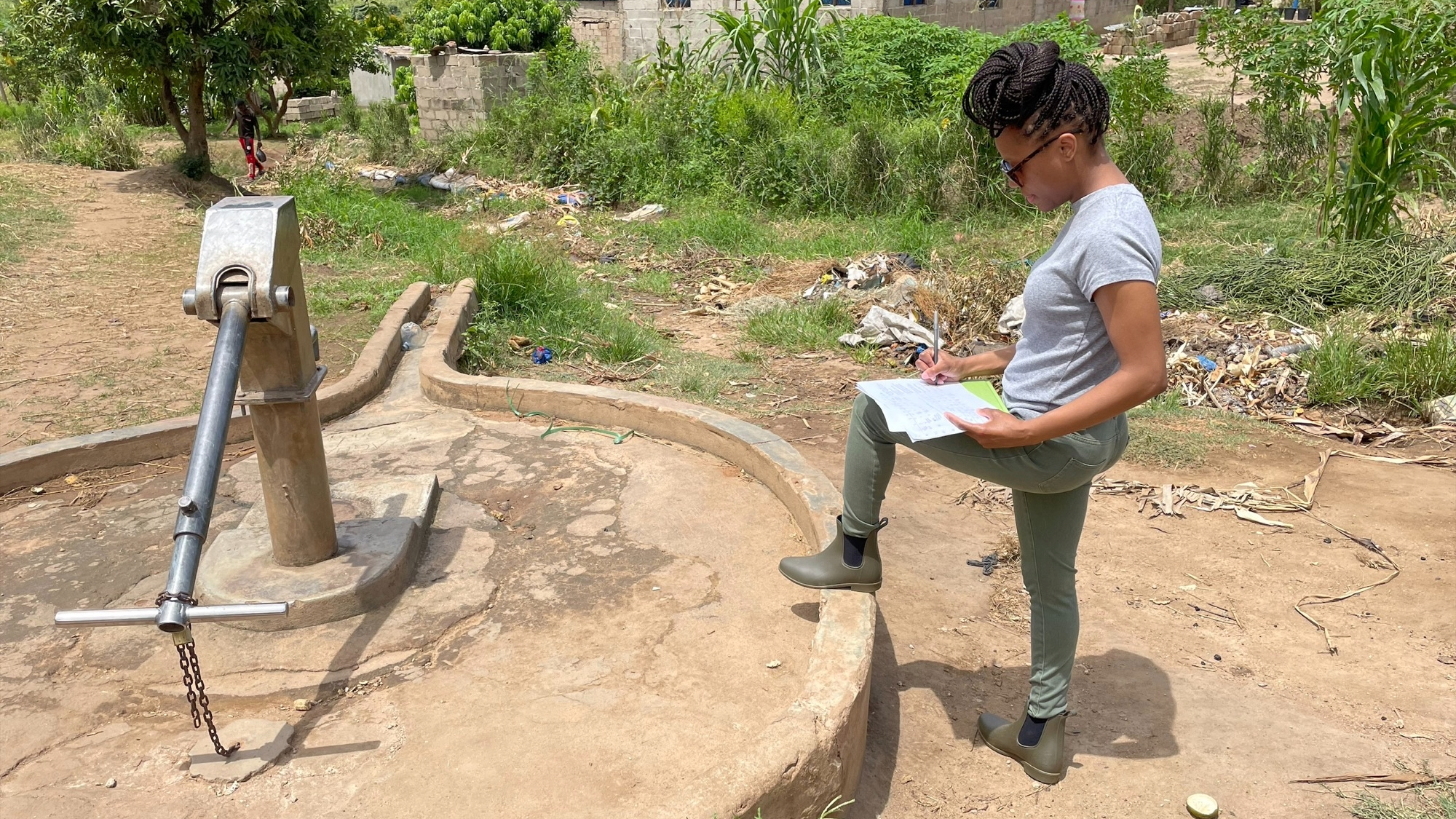 Mozambique-Cholera-2 Dr. Frederica Lamar completing a Sanitary Inspection Form for a hand pump well