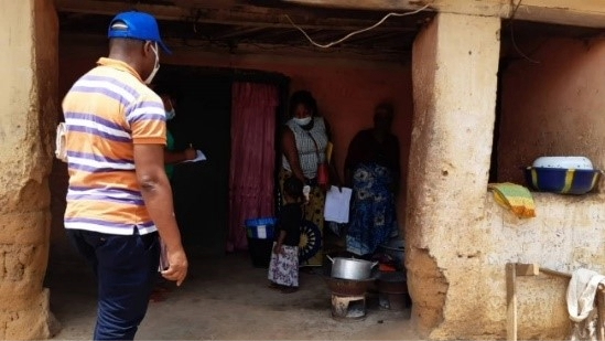 Training-Epidemiologists-in-Guinea-2 An FETP resident looking for Ebola contacts standing outside a home