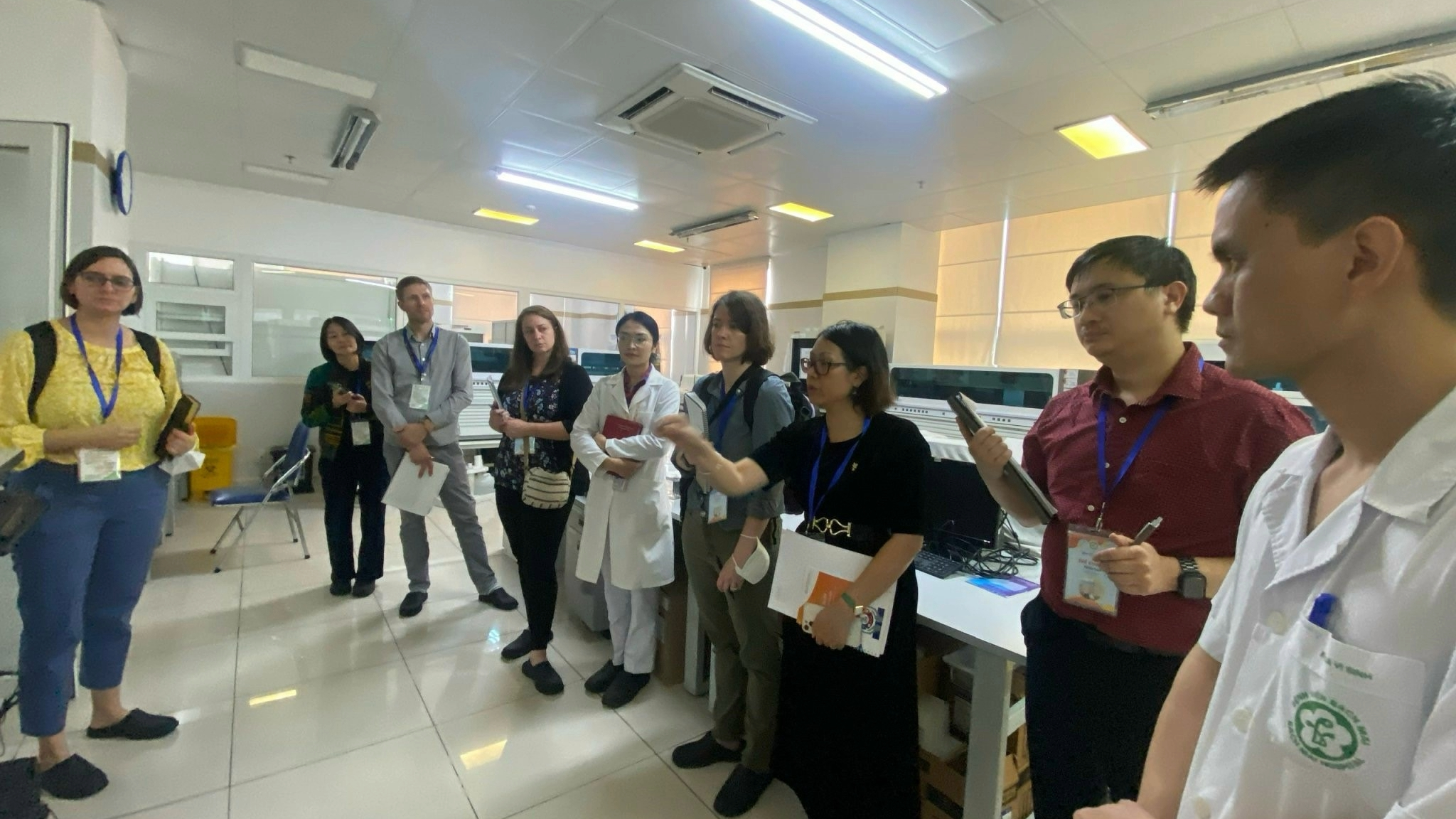 Stories-Vietnam Genome Sequencing A group of men and woman standing in a room