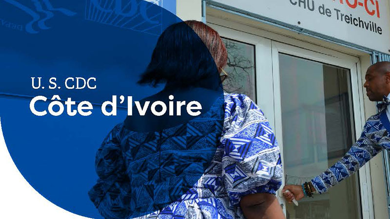 Two people entering a building marked "U.S. CDC Côte d'Ivoire" at CHU de Treichville.
