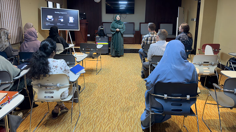 Lab twinning program MENA A diverse group attends a workshop, listening to a speaker in a classroom setting.