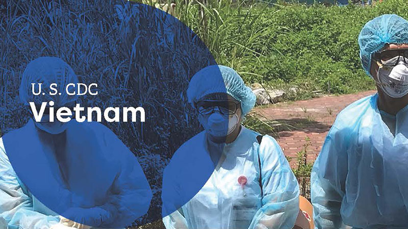 Group of healthcare workers in blue gowns and masks with "U.S. CDC Vietnam" text.