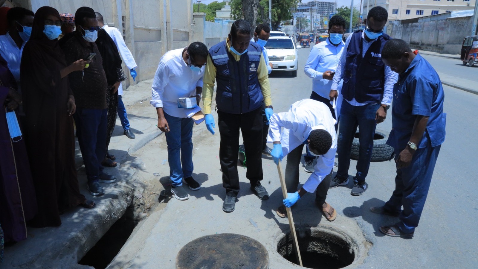 Somalia FETP 16x9 A group of individuals in blue gloves and face masks collecting environmental samples