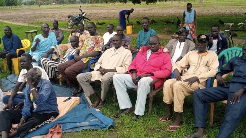SouthSudan_CommunityOutreach_Photo_002 A group of people are seated outdoors.