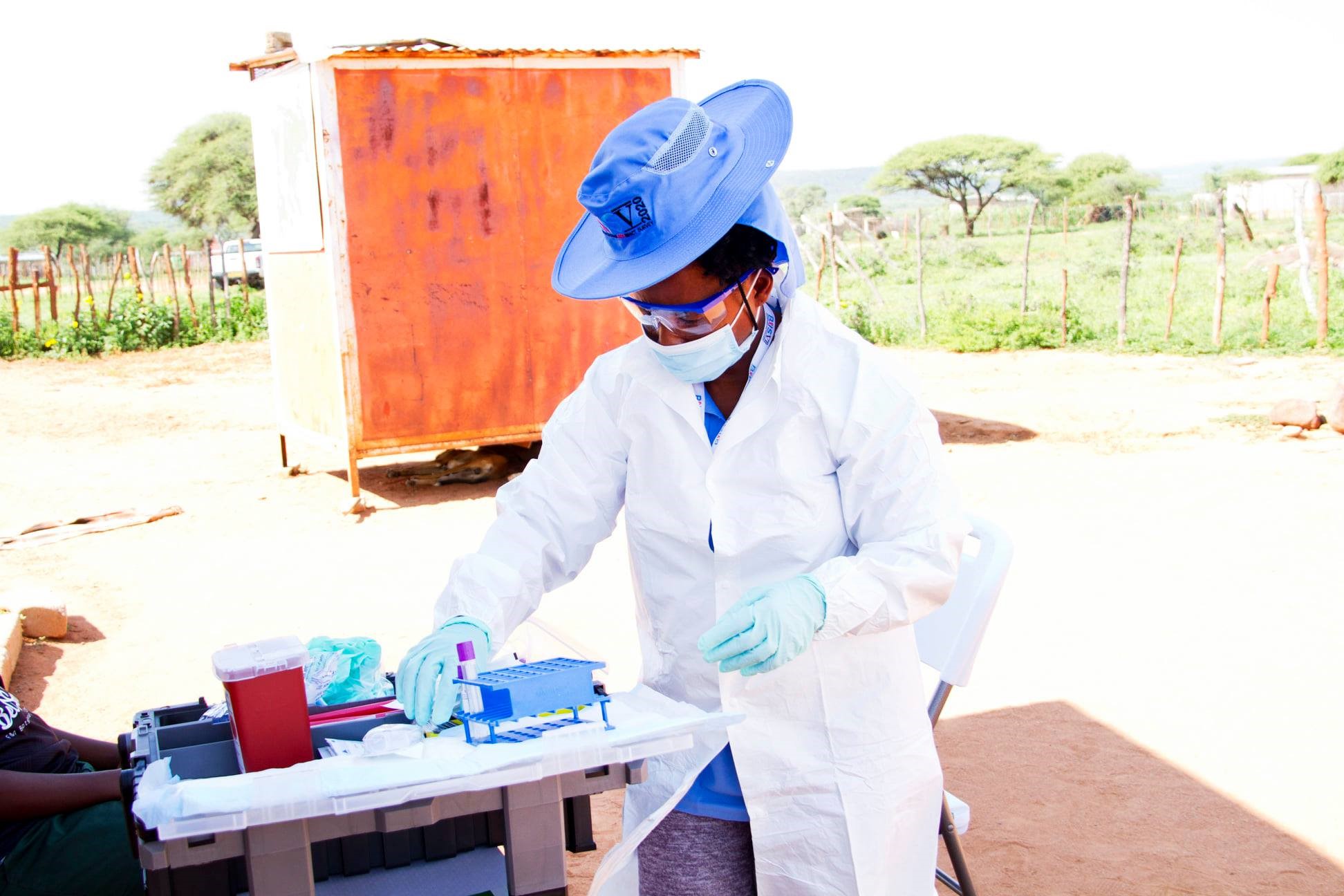 -- title missing -- Photo of a healthcare worker providing field testing for HIV.