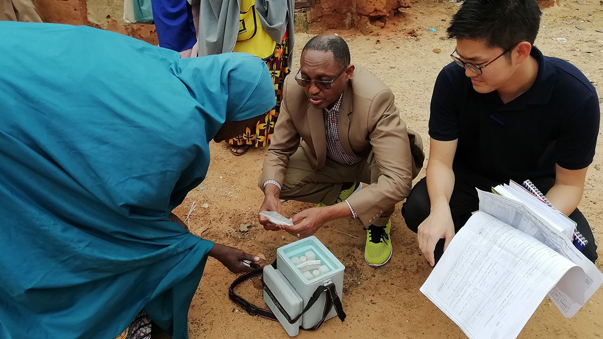 STOP Program participant and mentor provide supportive supervision and review the contents of the vaccine box with a frontline vaccinator during a polio campaign in Sokoto State, Nigeria. Frontline vaccine worker talks to mentors to review the contents of the vaccine box with a frontline vaccinator during a polio campaign in Sokoto State, Nigeria.