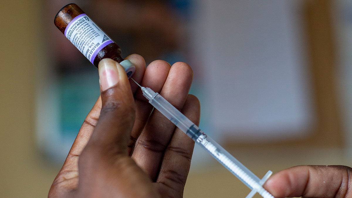 A pair of hands holding a syringe A pair of hands holding a syringe.