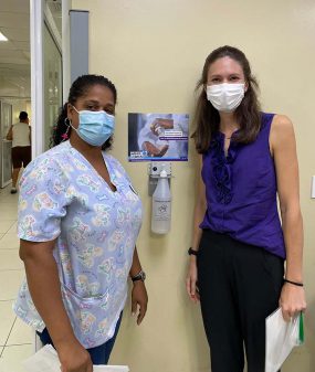 Christina Craig and Dania Romero CDC Behavioral Scientist Christina Craig (right) and nurse Dania Romero (left) pose with a message-tested hand hygiene poster and new ABHR dispenser in regional hospital in Moca, Dominican Republic.