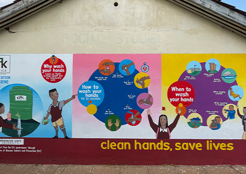 Mural on school building, Kenya. Mural on school building illustrating handwashing steps and encouraging students to practice hand hygiene. Nairobi, Kenya.