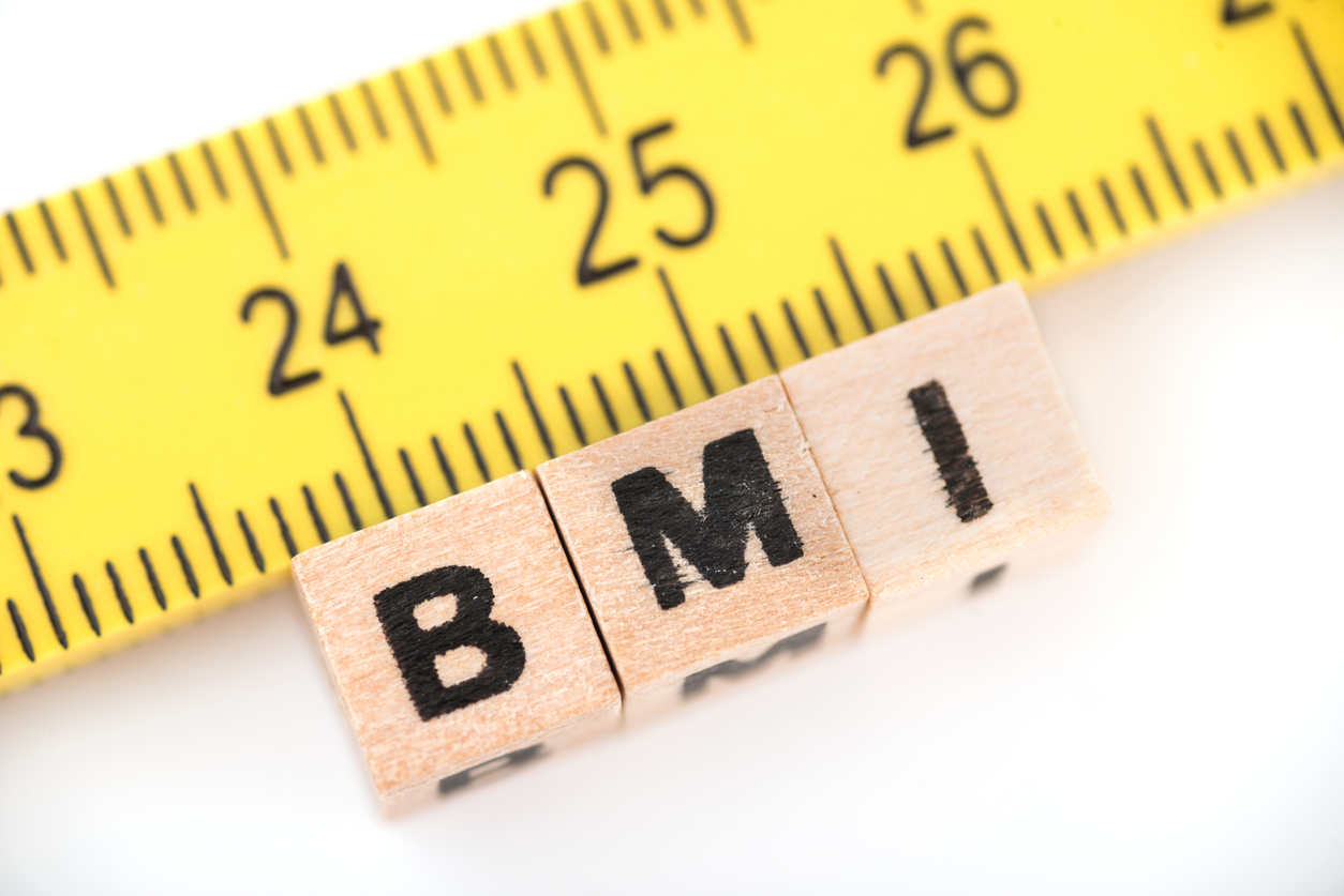 BMI and tape measure The letters "B, M, I" spelled out on blocks below a tape measure.