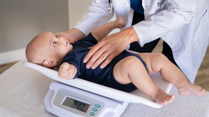 Baby on scales Baby on scales in a health care setting.