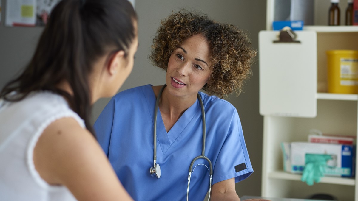 Clinician talking to patient Healthcare provider talking to a patient in a doctor's office