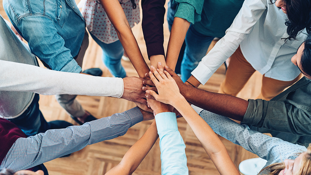 Hands in collaboration A group of individuals holding hands together