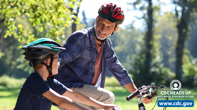 Father and son with bike helmets Father and son riding bikes and wearing helmets.