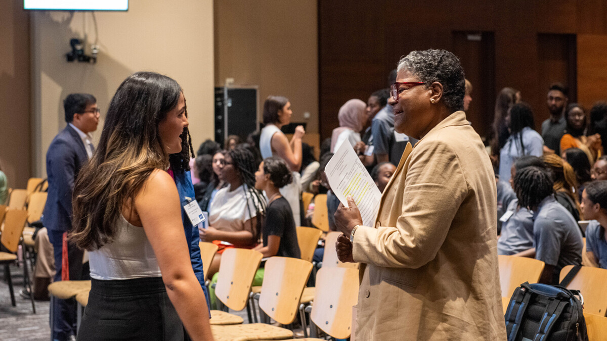CDC's Office of Health Equity Director Dr. Liburd speaking to a student at CDC showcase.