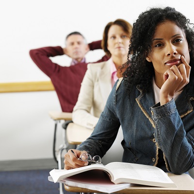 adult students paying attention in class Adults learning about health in an adult education classroom.