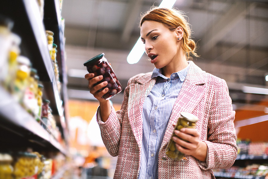 Woman buying food at grocery store. Woman buying food at grocery store.
