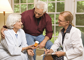older-adults-with-doctor.jpg Senior couple discussing medication with a care physician.