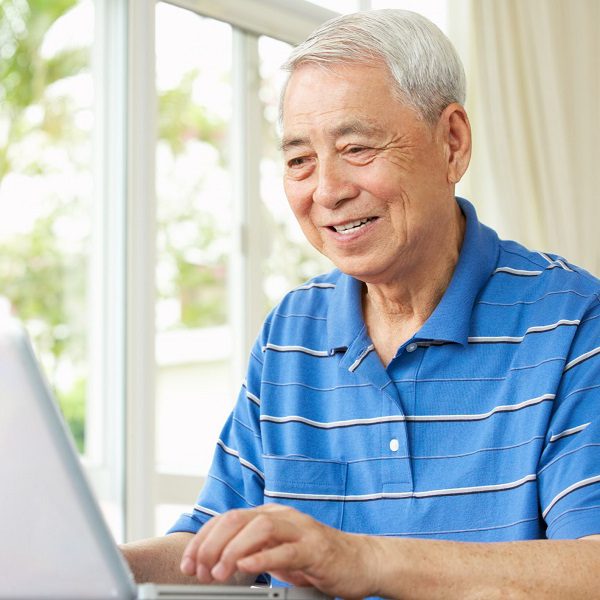 A senior man using a laptop at home Senior man using laptop computer