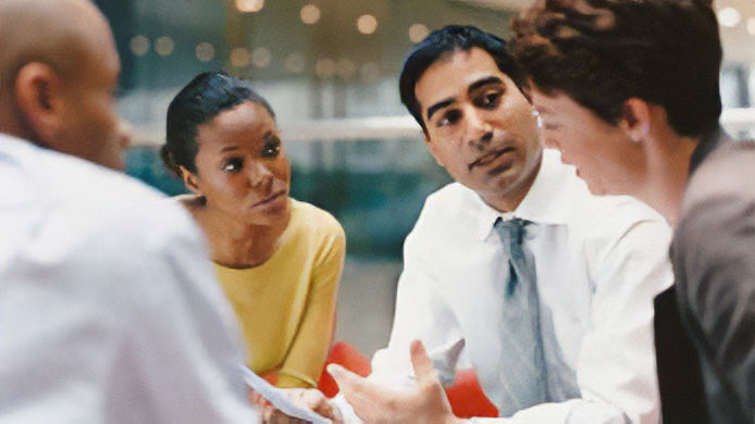 Business people in meeting Group of four people in a meeting.