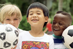 003359CH_small.jpg Three boys holding soccer balls, smiling.