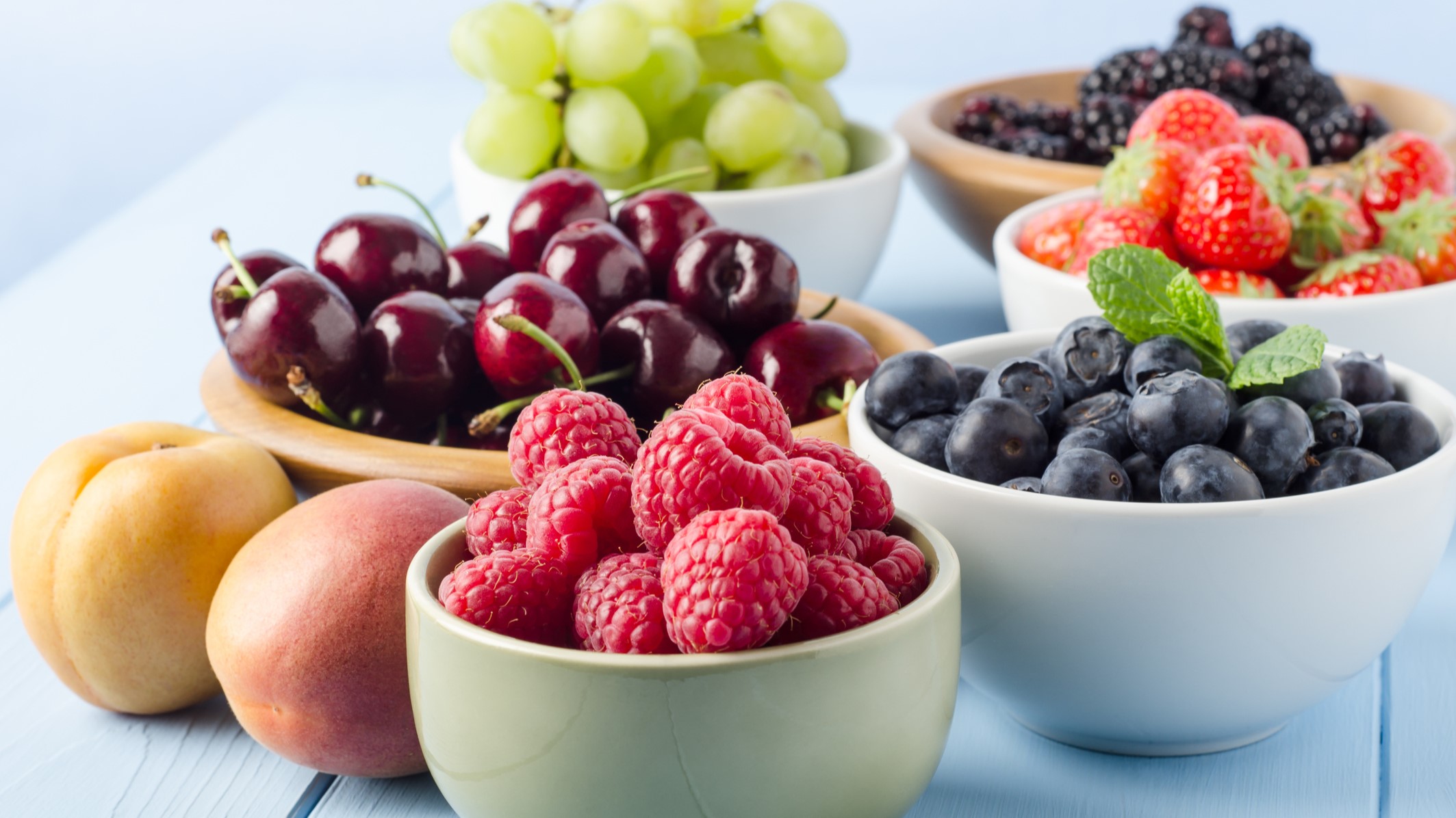 — title missing — Small bowls with fruit including raspberries, cherries, and blueberries.