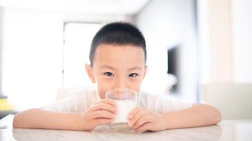 — title missing — Boy drinking a glass of milk.