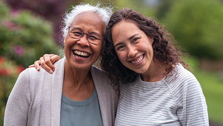 — title missing — Mother and daughter smiling and posing for camera.