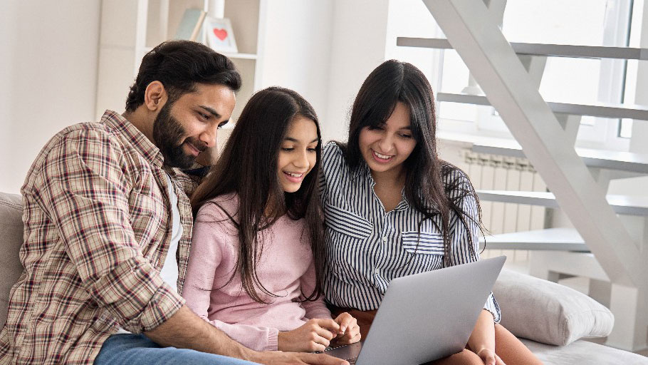 About Parents and child looking for information from a laptop.
