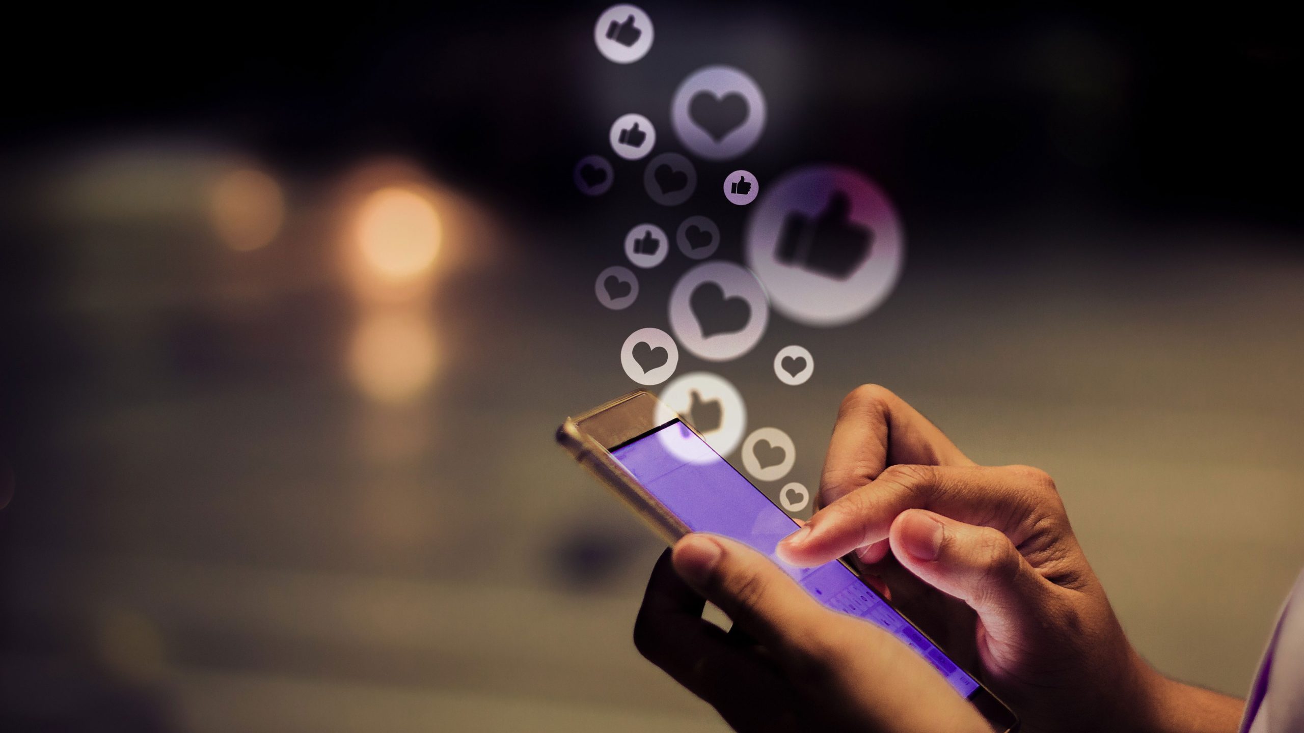 Social Media Hand holding phone using social media with AI generated icons.