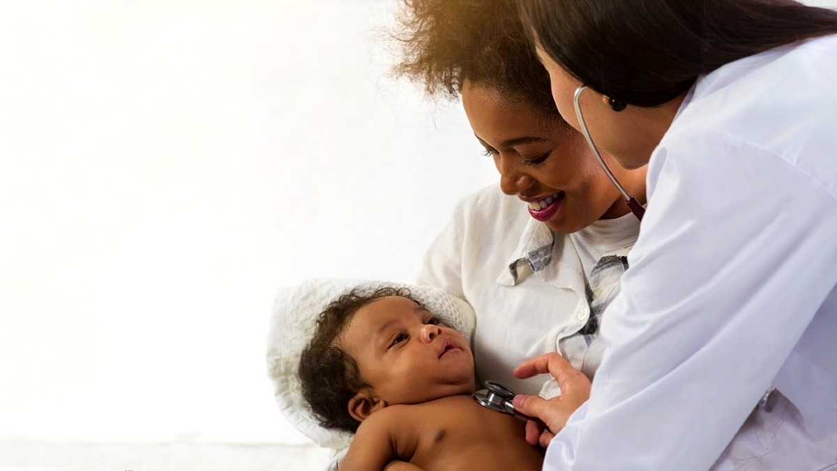 Pediatrician with mother and infant Mom, baby and health care provider
