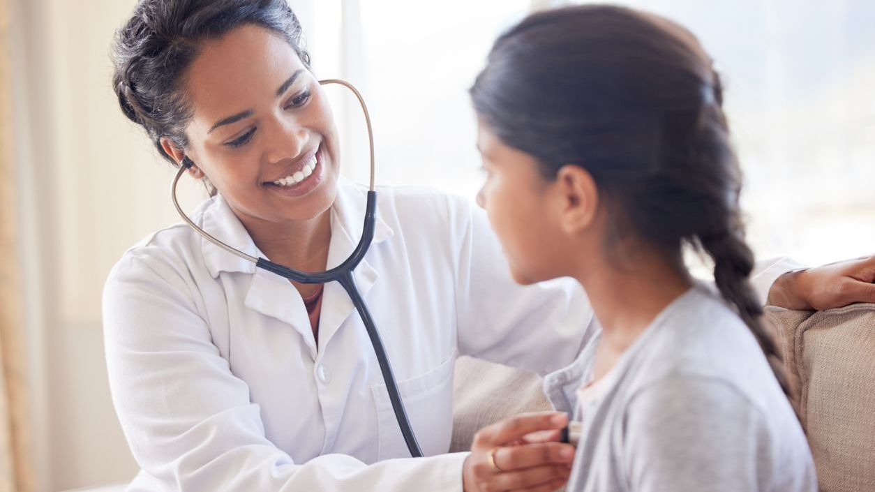 Pediatrician A female doctor giving a girl an examination