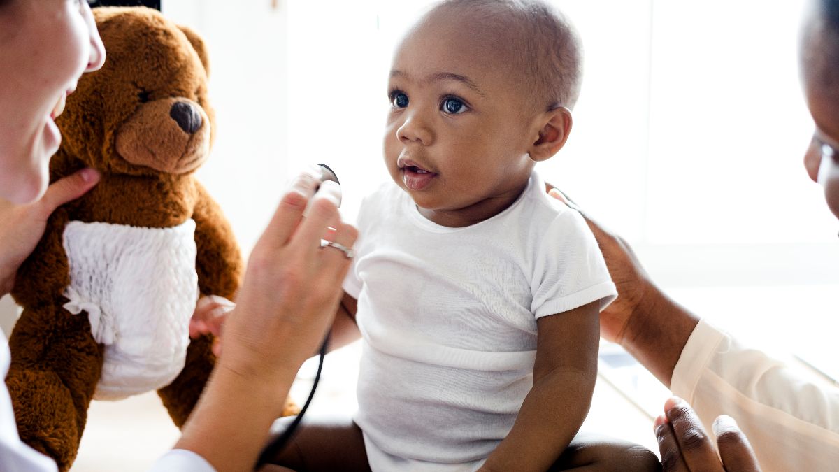 — title missing — doctor listening to boy's heart