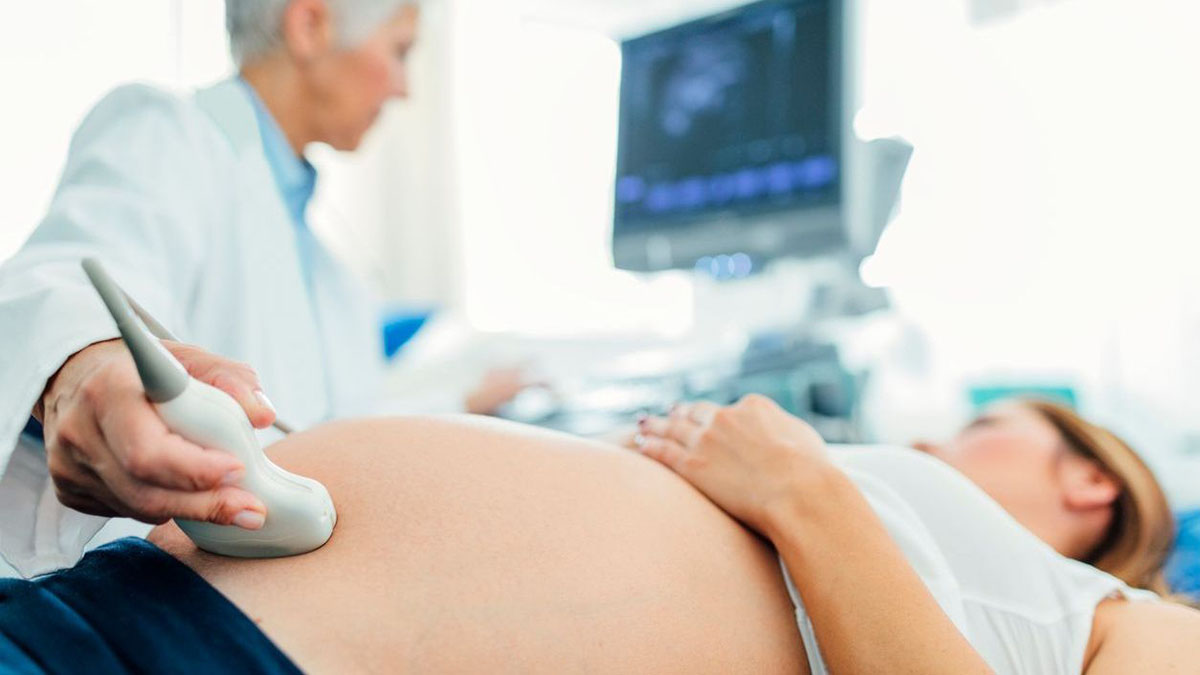 Doctor using ultrasound on a pregnant woman Doctor using ultrasound on a pregnant woman
