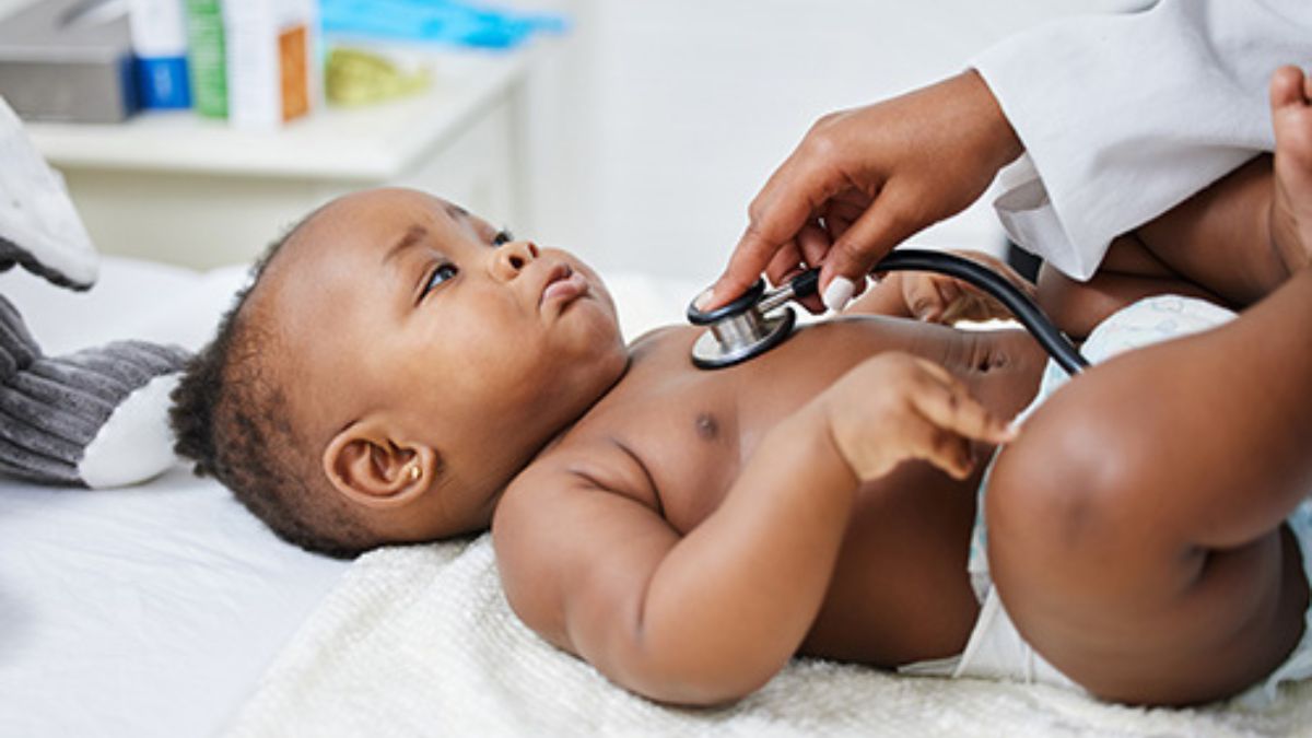 Doctor listening to infant's heart Doctor listening to infant's heart