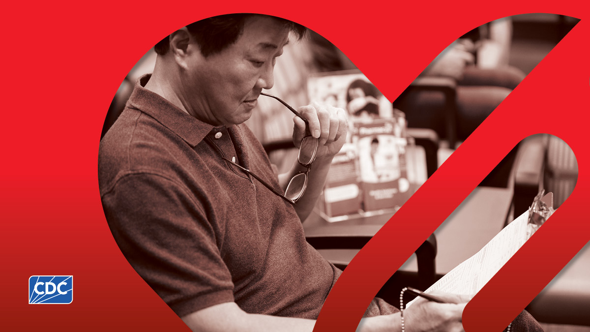 HVD partner thumbnail Image of man holding glasses up while reading a clipboard.