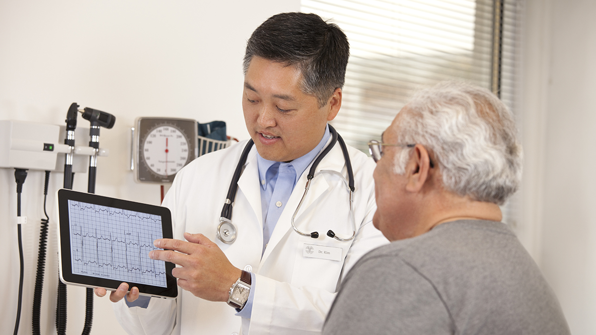 about-hd.jpg A pharmacist talking with a customer about his medication.
