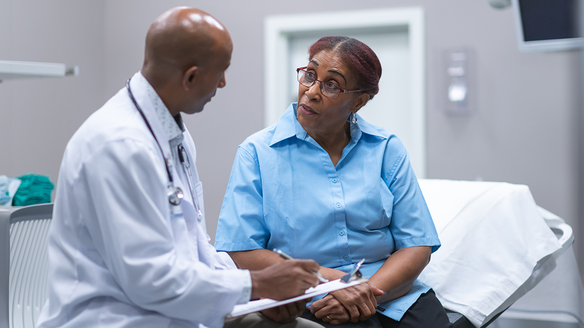 cardiomyopathy.jpg A physician talking to a patient during a medical exam.