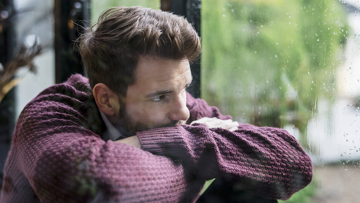 mood-disorders Thoughtful man looking out the window