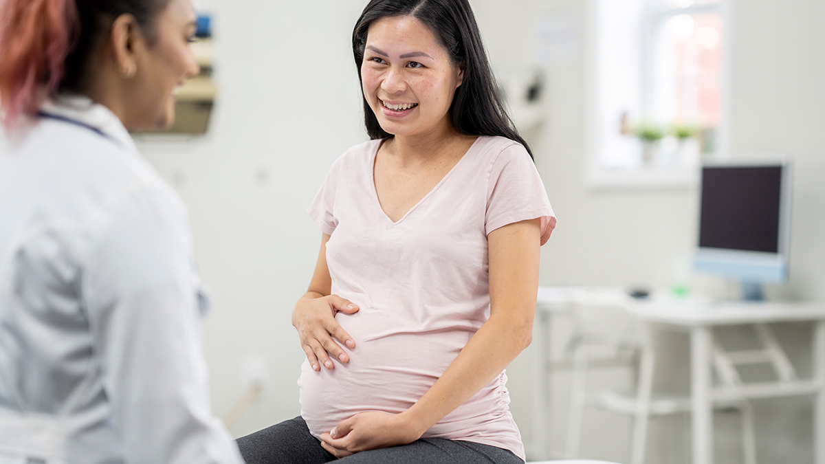 Clinical Overview of Perinatal Hepatitis B Thumbnail A pregnant woman sitting in a doctor's office speaking to her doctor
